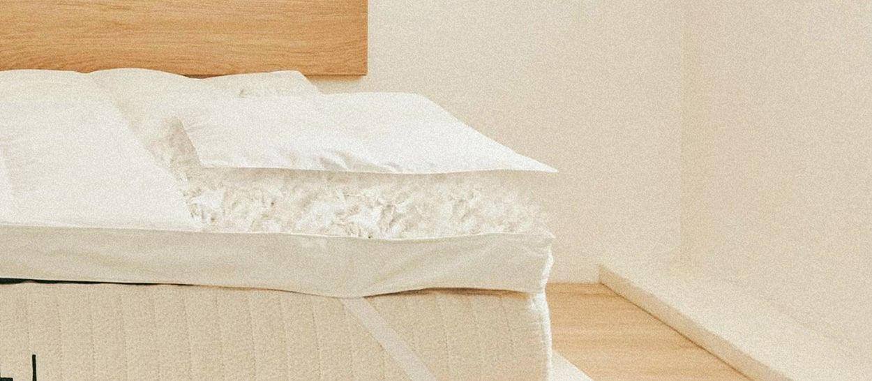 Lit en bois clair équipé d’un surmatelas naturel Kipli en plumes et duvet