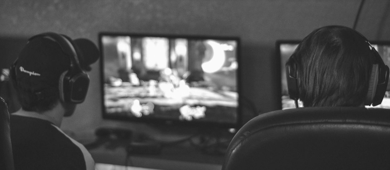 Adolescents devant des écrans de jeu vidéo, illustrant l’exposition aux contenus numériques, la stimulation excessive et les risques de troubles du comportement liés à un usage prolongé des écrans.